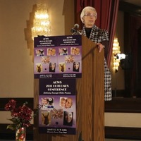 ACWS Executive Director Jan Reimer speaking at a podium during the 2011 Outcomes Conference.
